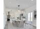 Bright dining area features stylish lighting, a sleek table set, and sliding glass doors to the outside at 61400 E 56 Ave, Strasburg, CO 80136