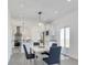 Dining room with seating for four in a bright space open to a modern kitchen and slider door at 61400 E 56 Ave, Strasburg, CO 80136