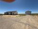 Charming single story home with a large storage shed on a bright and sunny day at 61400 E 56 Ave, Strasburg, CO 80136