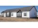 Charming, newly built, single-story home with black trim and a landscaped yard at 61400 E 56 Ave, Strasburg, CO 80136