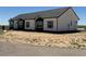 Beautiful single-story home with white siding, black trim, and gray shutters, new construction at 61400 E 56 Ave, Strasburg, CO 80136