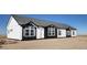 New home showing exterior with white siding, black trim, and windows, under construction at 61400 E 56 Ave, Strasburg, CO 80136