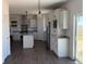 Bright kitchen features stainless steel appliances, granite counters and modern light fixtures at 61400 E 56 Ave, Strasburg, CO 80136