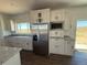 Modern kitchen features stainless refrigerator and granite countertops at 61400 E 56 Ave, Strasburg, CO 80136