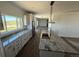 Modern kitchen features granite countertops, large center island, and backyard views at 61400 E 56 Ave, Strasburg, CO 80136
