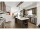 Modern kitchen with stainless steel appliances, granite counters, a kitchen island and ample cabinet space at 61400 E 56 Ave, Strasburg, CO 80136