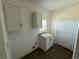 Convenient laundry room with utility sink, granite countertop, and storage at 61400 E 56 Ave, Strasburg, CO 80136