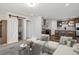 Modern living room seamlessly flows into an open-concept kitchen featuring stylish furnishings at 61400 E 56 Ave, Strasburg, CO 80136