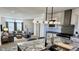 Open-concept living area with a gourmet kitchen, stainless steel appliances, and cozy seating at 61400 E 56 Ave, Strasburg, CO 80136