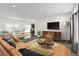 Spacious and inviting living room featuring comfortable seating, modern decor, and a TV at 61400 E 56 Ave, Strasburg, CO 80136