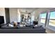 Open-concept home featuring living room, dining area and kitchen, with large windows and modern decor at 61400 E 56 Ave, Strasburg, CO 80136