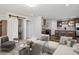 Cozy living room flowing into a modern kitchen and dining area, with stylish furniture and décor at 61400 E 56 Ave, Strasburg, CO 80136