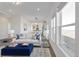 Bright living room with large windows, plush seating, and an open floor plan leading to the dining area at 61400 E 56 Ave, Strasburg, CO 80136