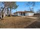 Spacious backyard featuring grass, trees, and a storage shed at 365 S Xapary St, Aurora, CO 80012