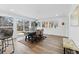 Open-concept dining area with large windows offers ample natural light and flows seamlessly with the rest of the home at 365 S Xapary St, Aurora, CO 80012