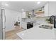 Modern kitchen featuring stainless steel appliances, stone countertops, and neutral color palette at 365 S Xapary St, Aurora, CO 80012