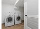 Bright laundry room featuring a washer, dryer, and access to storage at 365 S Xapary St, Aurora, CO 80012