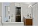 Well-appointed bathroom featuring a walk-in shower, dual sinks, and modern fixtures for convenience and style at 1159 S Otis Pl, Lakewood, CO 80232