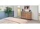 Well-lit bedroom featuring stylish dresser and neutral decor, creating a tranquil and inviting space at 1159 S Otis Pl, Lakewood, CO 80232