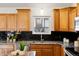 Stylish kitchen featuring granite countertops, stainless steel appliances, and modern black subway tile backsplash at 1159 S Otis Pl, Lakewood, CO 80232