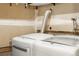 Efficient laundry room setup with modern washer and dryer units for convenient chores at 1159 S Otis Pl, Lakewood, CO 80232