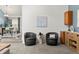 Cozy sitting area with two chairs, leading to the dining room at 1159 S Otis Pl, Lakewood, CO 80232