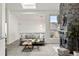 Bright living room featuring skylights and a stone fireplace at 1159 S Otis Pl, Lakewood, CO 80232
