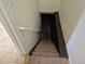 Stairs leading to the basement, featuring carpet and a handrail at 2832 S Mobile St, Aurora, CO 80013