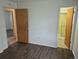 Bedroom featuring wood-look floors with entry to bath and hallway at 2832 S Mobile St, Aurora, CO 80013