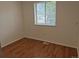 Bedroom featuring new wood-look floors and a window providing natural light at 2832 S Mobile St, Aurora, CO 80013