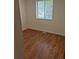 A bright bedroom features wood-look floors and a window providing natural light at 2832 S Mobile St, Aurora, CO 80013
