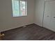 This bedroom includes wood-look floors, closet space, and a bright window at 2832 S Mobile St, Aurora, CO 80013