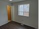 Bedroom featuring neutral paint, window and doorway at 2832 S Mobile St, Aurora, CO 80013