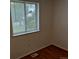 A bright bedroom features wood-look floors and a window at 2832 S Mobile St, Aurora, CO 80013
