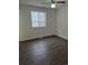 This bedroom features wood-look flooring and neutral walls at 2832 S Mobile St, Aurora, CO 80013