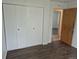 Bedroom features closet with mirrored doors and access to hallway at 2832 S Mobile St, Aurora, CO 80013