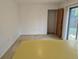 Empty dining room area with a sliding glass door, and a wooden closet door at 2832 S Mobile St, Aurora, CO 80013