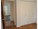 A doorway leads to a bedroom with wood-look floors and a closet at 2832 S Mobile St, Aurora, CO 80013