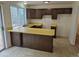 Kitchen with laminate countertops, dark cabinets, tile floor, and a sliding glass door to the backyard at 2832 S Mobile St, Aurora, CO 80013