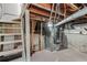 Spacious unfinished basement with exposed beams, concrete floor, ductwork, and furnace, ready for customization at 120 W Bayaud Ave, Denver, CO 80223