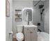 Modern bathroom featuring gray subway tile, black fixtures, and floating shelves for stylish storage at 120 W Bayaud Ave, Denver, CO 80223