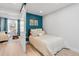 Cozy bedroom featuring a twin bed, sliding door and an adjacent sitting area at 120 W Bayaud Ave, Denver, CO 80223