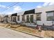 Charming townhomes showcasing unique front entryways with planters and black awnings along the sidewalk at 120 W Bayaud Ave, Denver, CO 80223