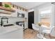 Bright kitchen with stainless steel appliances, white cabinets and a breakfast nook with a round table at 120 W Bayaud Ave, Denver, CO 80223