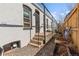 Property showcasing a cozy side yard with gravel, potted plants and direct access to the home at 120 W Bayaud Ave, Denver, CO 80223