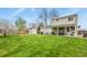 Large, green backyard features a shed and covered patio at 10645 Moore Ct, Broomfield, CO 80020