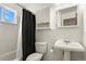 This bathroom features a shower-tub combo and a pedestal sink with a mirror at 10645 Moore Ct, Broomfield, CO 80020
