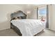 This bedroom features a decorative headboard and a window with natural light at 10645 Moore Ct, Broomfield, CO 80020