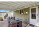 View of the covered patio with dining set and access to the backyard at 10645 Moore Ct, Broomfield, CO 80020
