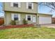 The front yard of this charming home features well-manicured lawn, beautiful shrubbery, and a two car garage at 10645 Moore Ct, Broomfield, CO 80020
